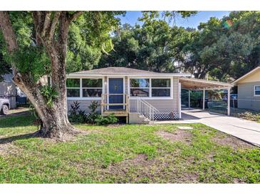 Quaint craftsman home with mature trees and a carport at 105 Mason St, Auburndale, FL 33823