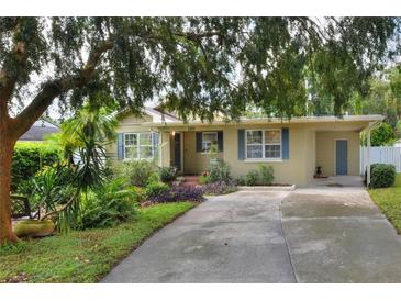 Front view of charming ranch house with mature landscaping at 1819 Meadowbrook Ave, Lakeland, FL 33803