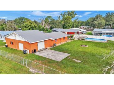 Aerial view of house, detached garage, large backyard, and pool at 4390 Sunnyside Dr, Lakeland, FL 33810