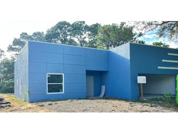 Newly constructed home with blue exterior and a modern design at 2626 Magnolia Cir, Lake Wales, FL 33898