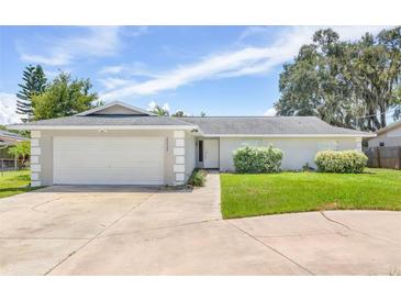Single story home with attached garage and manicured lawn at 2233 20Th Nw St, Winter Haven, FL 33881