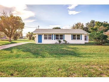 Single story home with a blue door and manicured lawn at 5144 Washington St, Lake Wales, FL 33859