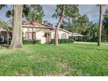 Charming house with lush landscaping and a carport at 1806 17Th Nw St, Winter Haven, FL 33881