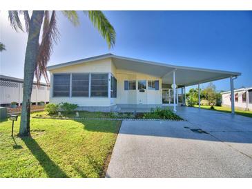 Yellow single-wide manufactured home with carport at 1742 Fox Hill Dr, Lakeland, FL 33810