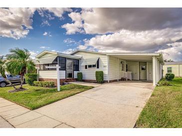 Single-wide manufactured home with carport and landscaping at 2211 Harbor Town Ln, Lakeland, FL 33810