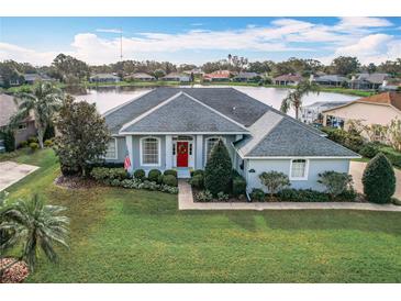 Aerial view of a single Gathering home community with lake at 6614 Englelake Dr, Lakeland, FL 33813