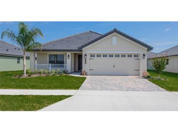 One-story house with a beige exterior, gray roof and a two-car garage at 4706 Grandview Glen Dr, Auburndale, FL 33823