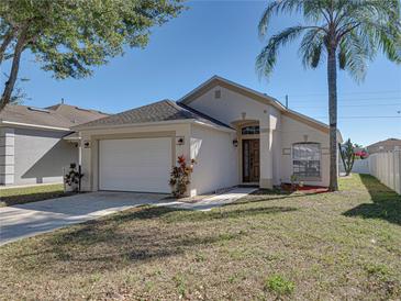 Single story home with a white garage door and brown front door at 742 Sonja Cir, Davenport, FL 33897