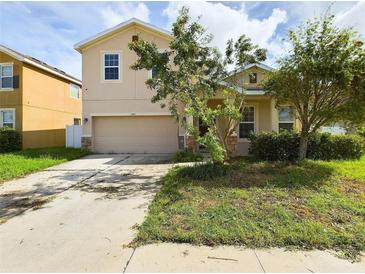 Tan two-story house with a two-car garage at 3484 Julius Estates Blvd, Winter Haven, FL 33881