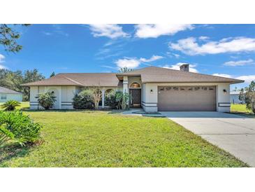 Single-story house with attached garage and well-maintained lawn at 4616 Musket Dr, Lakeland, FL 33810