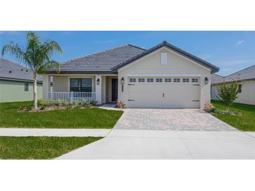 One-story home with a two-car garage and attractive landscaping at 4645 Grandview Glen Dr, Auburndale, FL 33823
