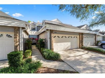 Two-story townhome with attached two-car garage and landscaped walkway at 3164 Stonewater Dr # 3164, Lakeland, FL 33803