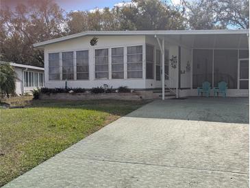 Single-wide manufactured home with carport and mature landscaping at 1610 Reynolds Rd # 211, Lakeland, FL 33801