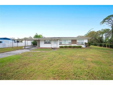 Ranch-style home with carport and spacious lawn at 1568 S Lake Shipp Dr, Winter Haven, FL 33880