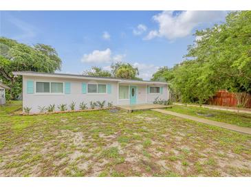 Charming ranch home with light-colored siding and teal accents at 801 E 24Th Ave, New Smyrna Beach, FL 32169