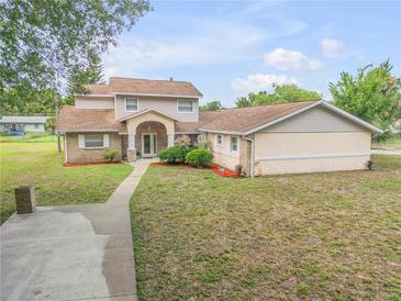 Two story home with a pool and detached garage at 299 W Hickory Ave, Oak Hill, FL 32759