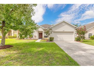 Single-story house with attached garage, well-manicured lawn, and driveway at 117 Opal Hill Cir, Daytona Beach, FL 32124