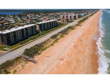 Aerial view of oceanfront building and beach access at 3180 Ocean Shore Blvd # 208, Ormond Beach, FL 32176