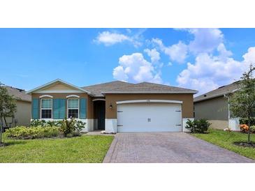 One-story home with a two-car garage and nicely landscaped yard at 1726 Red Rock Rd, New Smyrna Beach, FL 32168