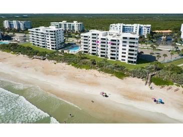 Aerial view of an oceanfront condo building at 5301 S Atlantic Ave # 52, New Smyrna Beach, FL 32169