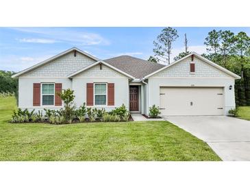 Two-story home with attractive front yard landscaping at 350 Sunset Point Dr, Ormond Beach, FL 32174