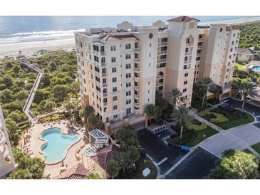 Aerial view of beachfront condo building with pool and ocean views at 253 Minorca Beach Way # 202, New Smyrna Beach, FL 32169