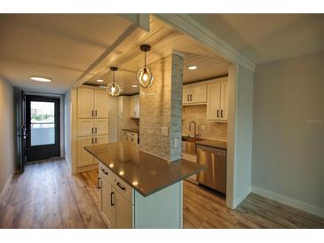Modern kitchen with island and stainless steel appliances at 101 N Riverside Dr # 4140, New Smyrna Beach, FL 32168
