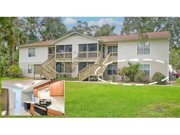 Two-story building with screened porch and landscaping at 1600 Big Tree Rd # D2, South Daytona, FL 32119