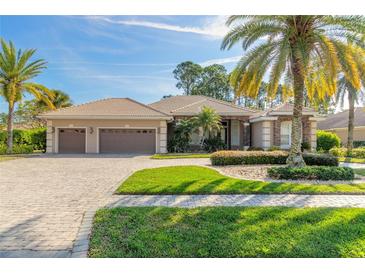 Two-story home with three car garage and landscaped yard at 728 Sea Duck Dr, Daytona Beach, FL 32119