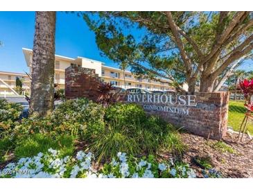 Riverhouse Condominium sign with landscaping at 721 S Beach St # 214A, Daytona Beach, FL 32114