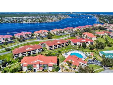 Aerial view of waterfront community with pool and lush landscaping at 452 Bouchelle Dr # 303, New Smyrna Beach, FL 32169