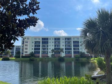 Building exterior showcasing a waterfront property with lush landscaping at 5300 S Atlantic Ave # 15-305, New Smyrna Beach, FL 32169