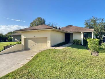 Single-story home with attached garage and well-manicured lawn at 120 Oakmont Ln, New Smyrna Beach, FL 32168