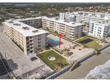 Aerial view of condo building with pool and beach access at 4155 S Atlantic Ave # 1030, New Smyrna Beach, FL 32169