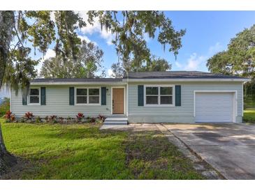 Newly renovated light green house with landscaping at 710 Corbin Park Rd, New Smyrna Beach, FL 32168