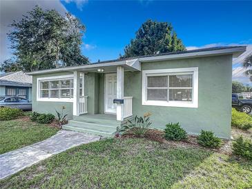 Charming bungalow with a newly painted exterior and well-manicured lawn at 409 N Ridgewood Ave, Edgewater, FL 32132