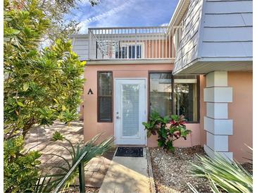 Inviting condo exterior with lush landscaping and private entrance at 4150 S Atlantic Ave # 103A, New Smyrna Beach, FL 32169