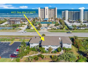 Aerial view of condo community near the beach with pool and tennis courts at 4411 Sea Mist Ct # 275, New Smyrna Beach, FL 32169