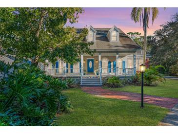Two-story house with blue shutters, a porch, and a brick walkway at 535 Valley Stream Dr, Geneva, FL 32732