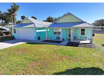 Cute beach cottage with metal roof, covered porch, and large yard at 152 Coleman St, Edgewater, FL 32141