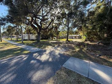 A view of the front yard from the street with trees and a camper at 3258 S Ridgewood Ave, Edgewater, FL 32141