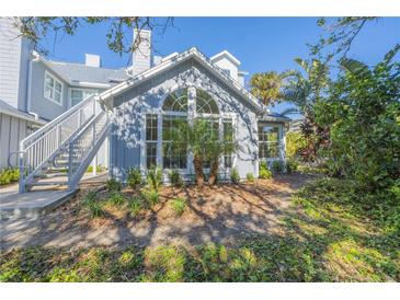 Updated condo building exterior with landscaping and a private staircase at 4278 Sun Village Ct # 27D, New Smyrna Beach, FL 32169