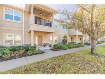 Inviting two-story townhome with a covered balcony, front yard landscaping, and a paved walkway at 3414 Medici Blvd, New Smyrna Beach, FL 32168