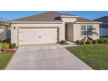 One-story home with attached garage and well-manicured lawn at 815 Sky Haven Way, New Smyrna Beach, FL 32168
