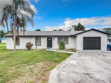 Newly renovated single story home with modern exterior and driveway at 1806 Bayview Dr, New Smyrna Beach, FL 32168