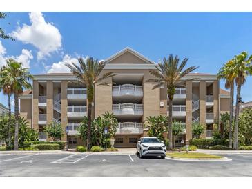 Exterior of a three-story condo building with palm trees and parking at 1106 Sunset View Cir # 201, Reunion, FL 34747