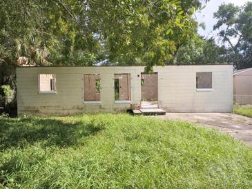 A fixer-upper home with a front yard at 4022 Shellman St, Orlando, FL 32811