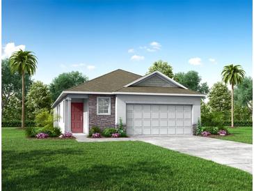 One-story home with two-car garage and landscaping at 1697 Andover Ridge Dr, Deland, FL 32720