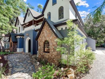 Two-story home with unique stone accents and landscaping at 13857 Marine Dr, Orlando, FL 32832