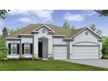 Two-story house with a three-car garage and landscaping at 2505 Lake Ruby Rd, Deland, FL 32724